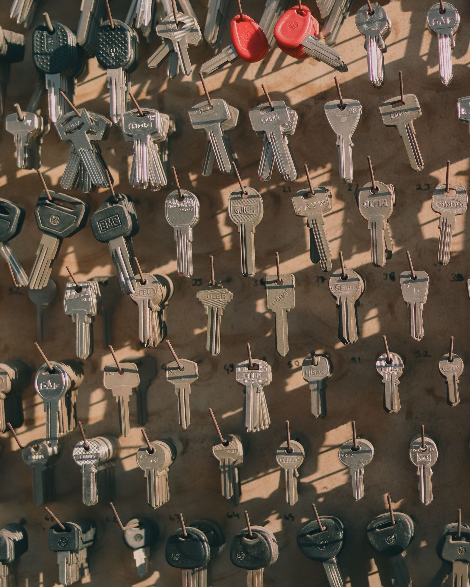 A wall of key blanks hanging on hooks
