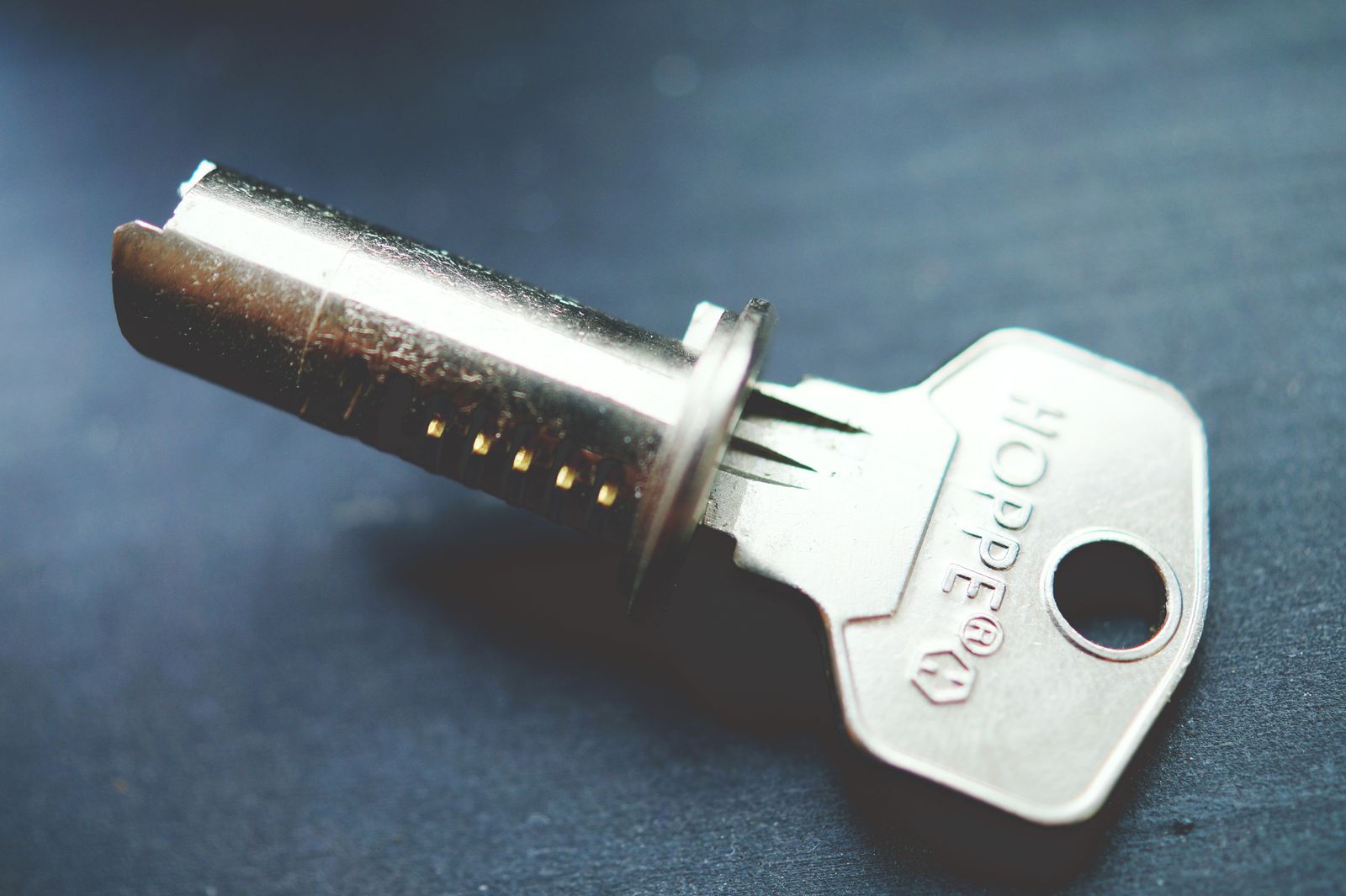 A lock cylinder beside its key