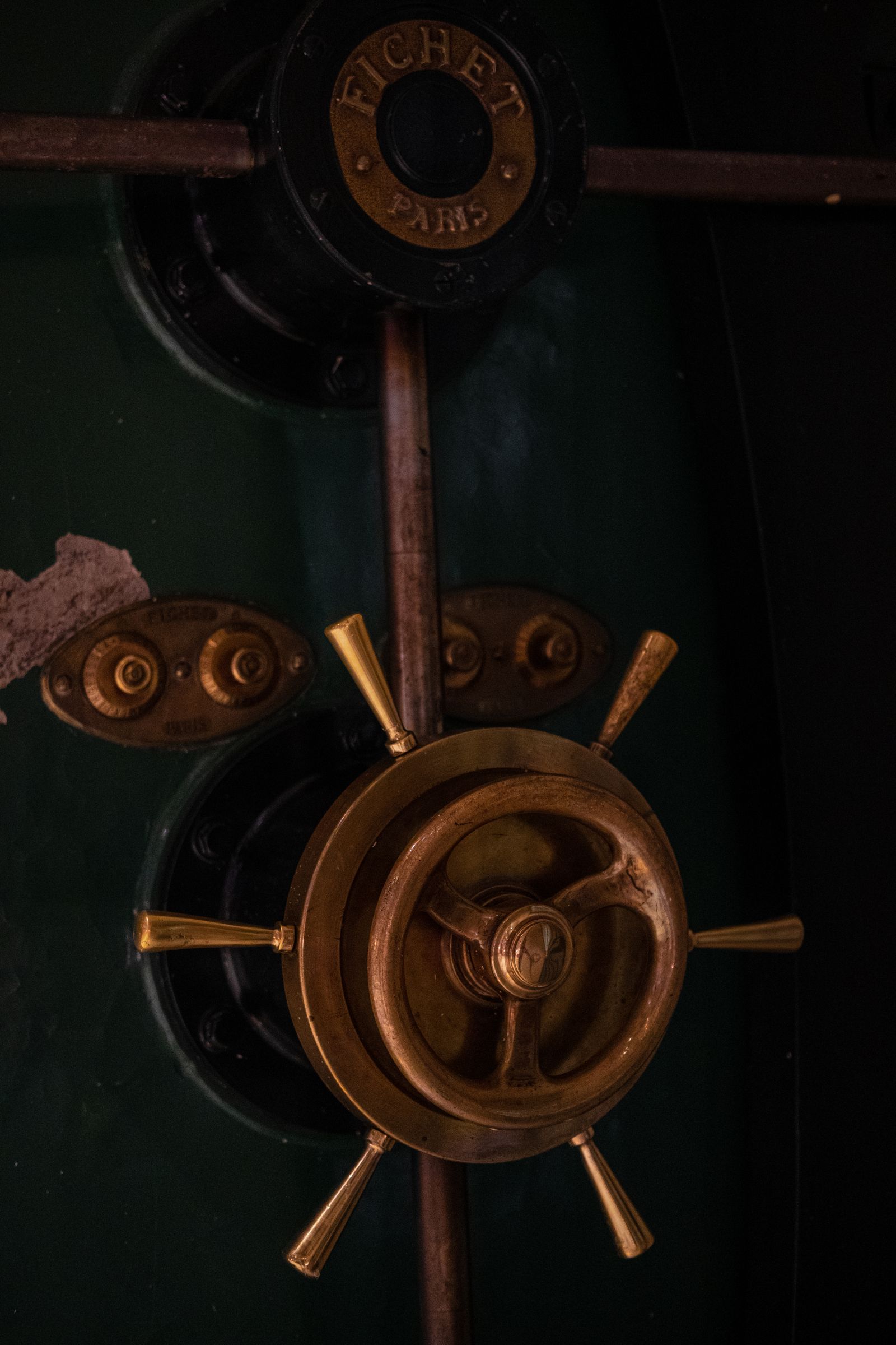 The wheel and dial on an old safe door